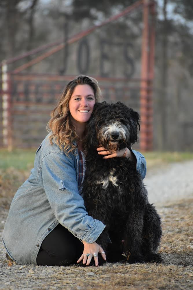 abstract sheepadoodle with his owner smiling.